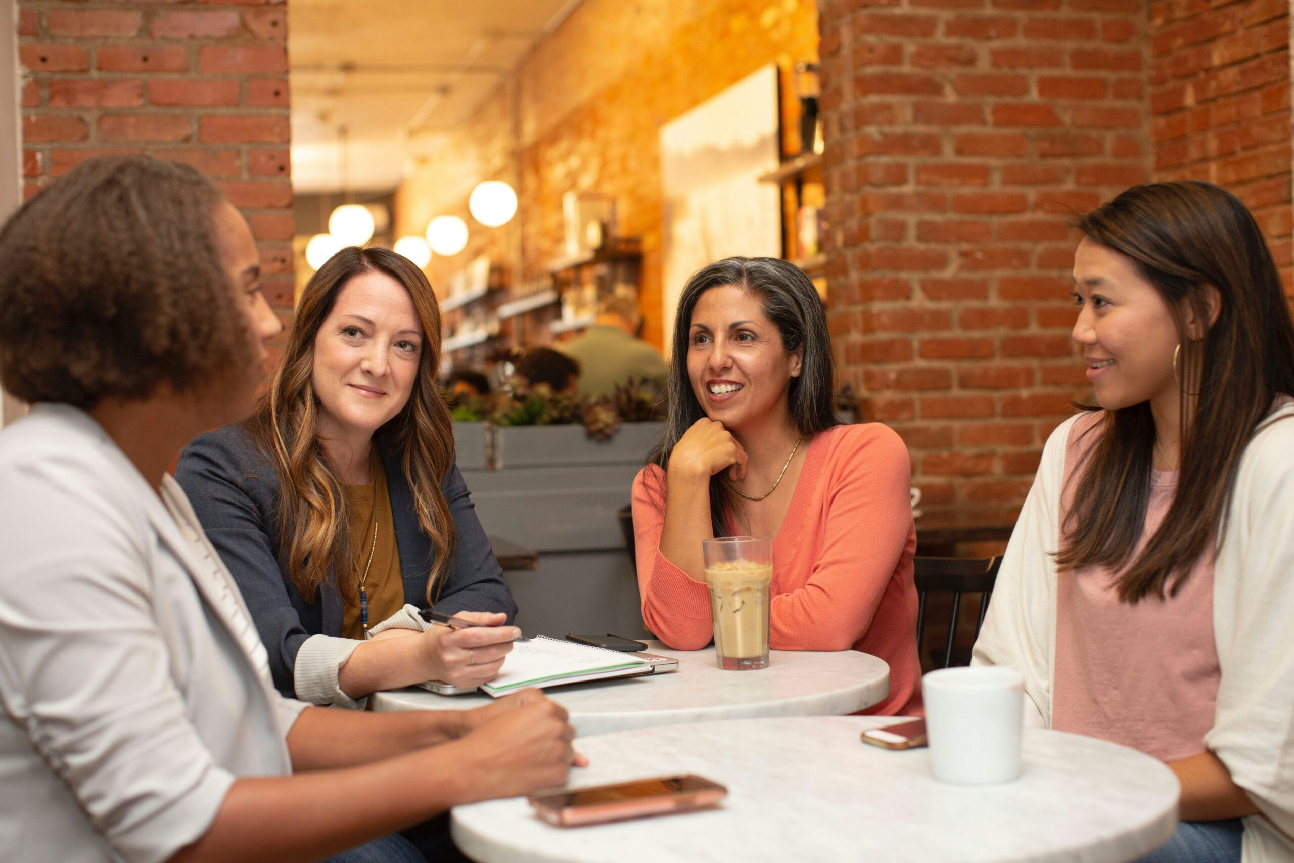 Four women working in a business meeting in a cafe coffee shop corporate vs commercial law